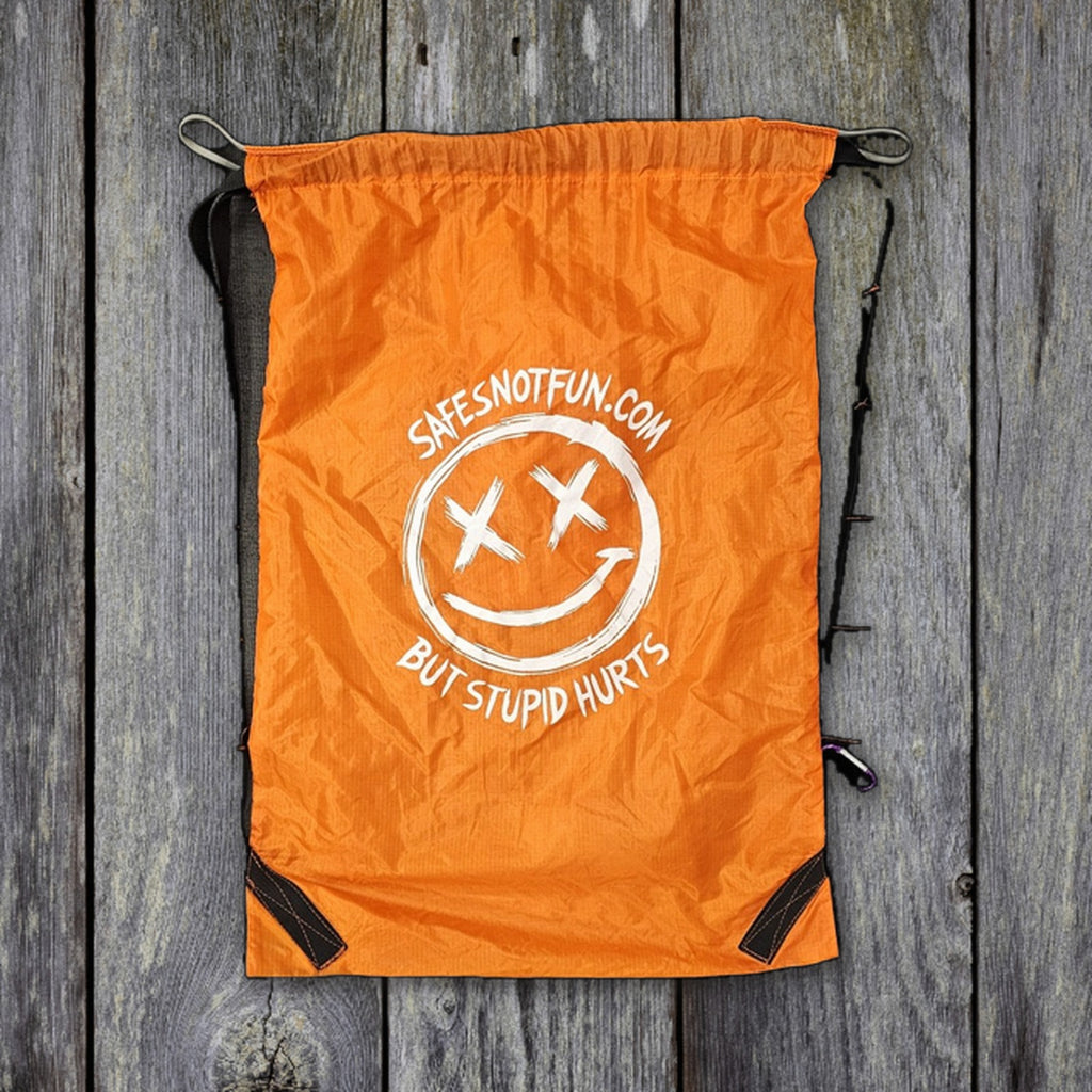 Safe's Not Fun drawstring bag 30x50 with straps on weathered wood