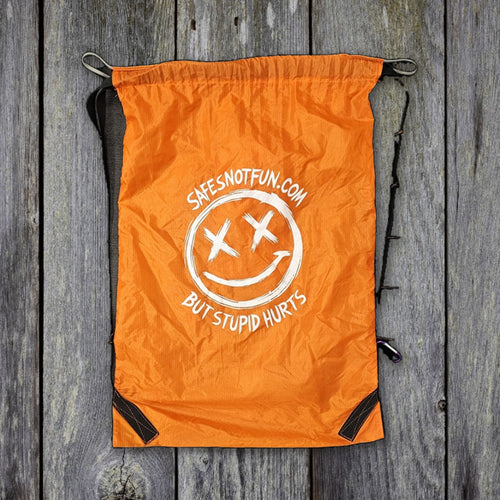 Safe's Not Fun drawstring bag 30x50 with straps on weathered wood
